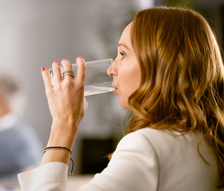 Lady drinking glass of water